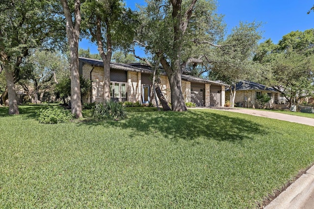 11008 Arch Ter, Austin, TX 78750 - mid-century home featuring concrete driveway, a garage, and a front lawn