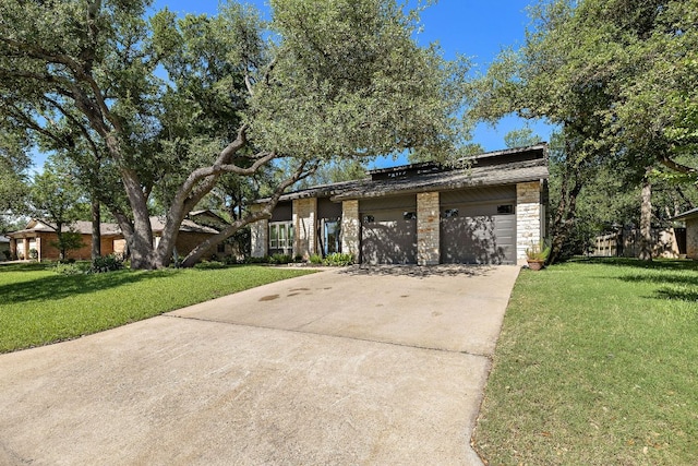 11008 Arch Ter, Austin, TX 78750 - mid-century home featuring driveway, a front yard, a garage, and stone siding