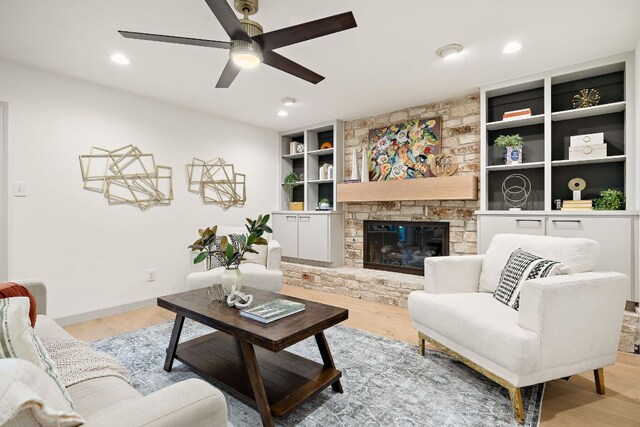11008 Arch Ter, Austin, TX 78750 - living room featuring a ceiling fan, light wood-type flooring, built in features, a fireplace, and recessed lighting