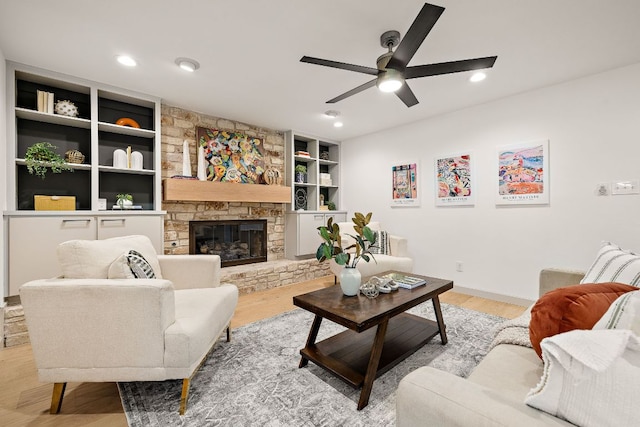 11008 Arch Ter, Austin, TX 78750 - living area with a ceiling fan, built in shelves, light wood-style flooring, a fireplace, and recessed lighting
