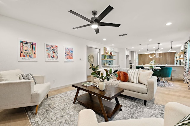 11008 Arch Ter, Austin, TX 78750 - living area with light wood-style floors, recessed lighting, a ceiling fan, and baseboards