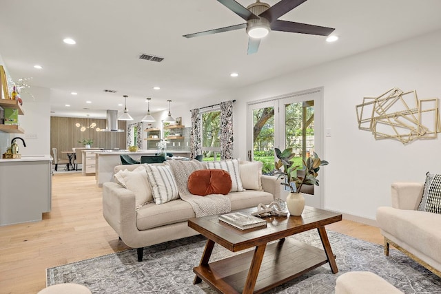 11008 Arch Ter, Austin, TX 78750 - living room featuring light wood-type flooring, a chandelier, recessed lighting, and a ceiling fan