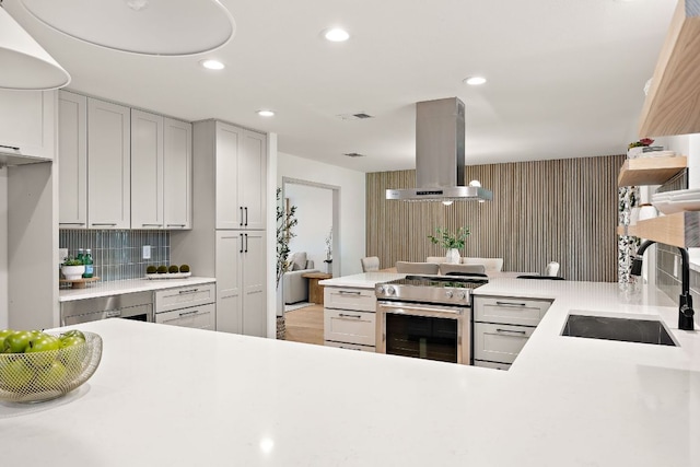 11008 Arch Ter, Austin, TX 78750 - kitchen featuring extractor fan, stainless steel stove, a sink, light countertops, and decorative backsplash