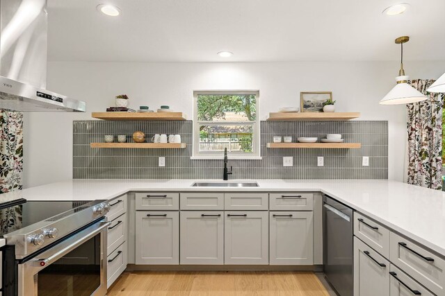 11008 Arch Ter, Austin, TX 78750 - kitchen featuring open shelves, wall chimney range hood, appliances with stainless steel finishes, tasteful backsplash, and recessed lighting