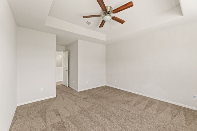 1701 S Bell Blvd Unit 101, Cedar Park, TX 78613 - carpeted spare room featuring a tray ceiling, a ceiling fan, and baseboards
