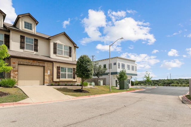 1701 S Bell Blvd Unit 101, Cedar Park, TX 78613 - view of front facade featuring stucco siding, stone siding, driveway, and an attached garage