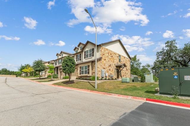 1701 S Bell Blvd Unit 101, Cedar Park, TX 78613 - traditional-style house featuring stone siding, stucco siding, central air condition unit, and a front lawn