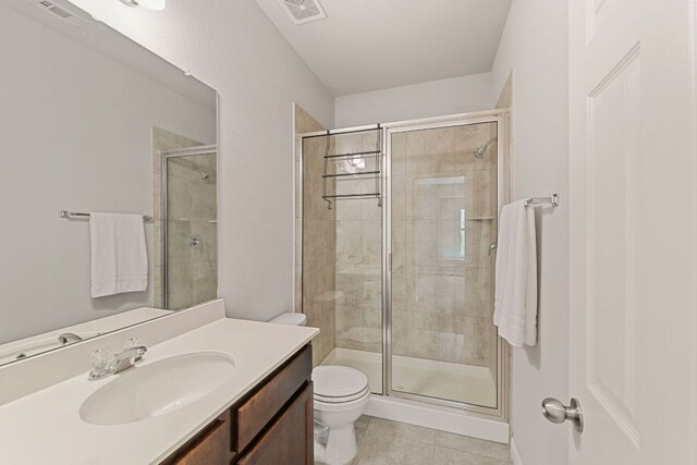 1701 S Bell Blvd Unit 101, Cedar Park, TX 78613 - bathroom featuring toilet, vanity, tile patterned flooring, and a stall shower