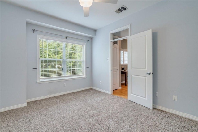 2115 Bluebonnet Ln Unit 3B, Austin, TX 78704 - unfurnished bedroom featuring light carpet, baseboards, and ceiling fan
