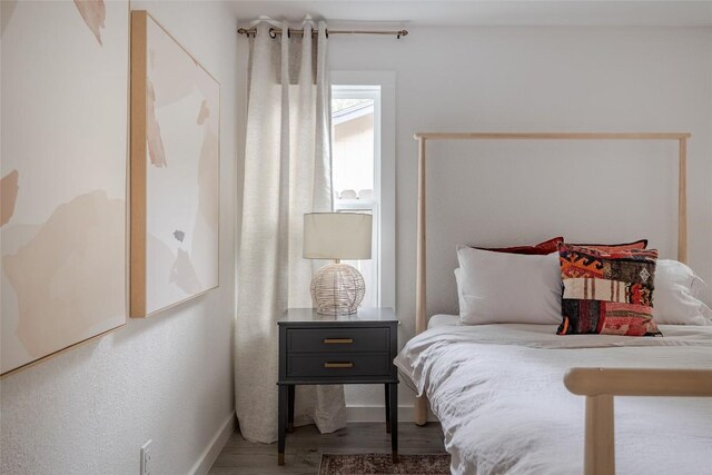 4601 Candletree Ln, Austin, TX 78744 - bedroom featuring wood finished floors and baseboards