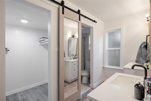 4601 Candletree Ln, Austin, TX 78744 - full bathroom with vanity, wood finished floors, toilet, and baseboards