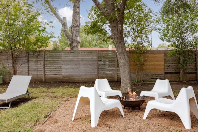 4601 Candletree Ln, Austin, TX 78744 - fenced backyard with an outdoor fire pit