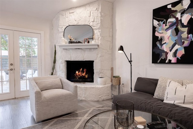 4601 Candletree Ln, Austin, TX 78744 - living area with french doors, wood finished floors, and a fireplace