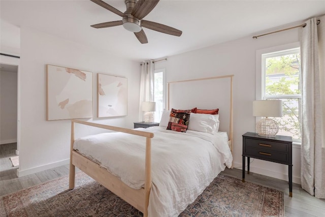 4601 Candletree Ln, Austin, TX 78744 - bedroom featuring wood finished floors, baseboards, and ceiling fan