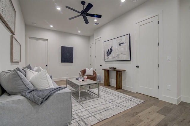 19543 Lakehurst Loop, Spicewood, TX 78669 - living area featuring wood finished floors, ceiling fan, baseboards, and recessed lighting