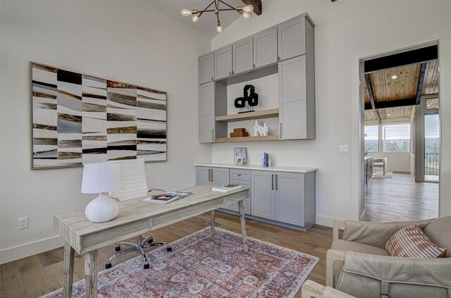 19543 Lakehurst Loop, Spicewood, TX 78669 - office with wood finished floors, baseboards, and vaulted ceiling
