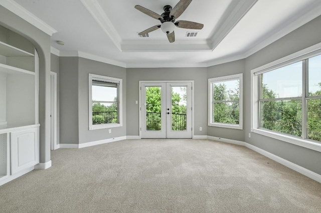 12004 Mira Mesa Dr, Austin, TX 78732 - empty room with a raised ceiling, plenty of natural light, light carpet, and crown molding