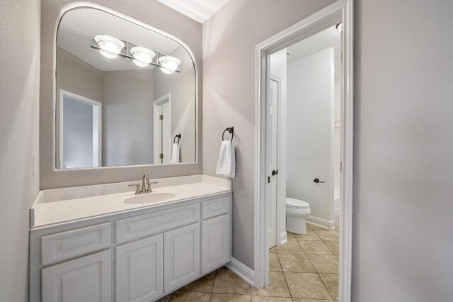 12004 Mira Mesa Dr, Austin, TX 78732 - bathroom with vanity, tile patterned floors, and toilet