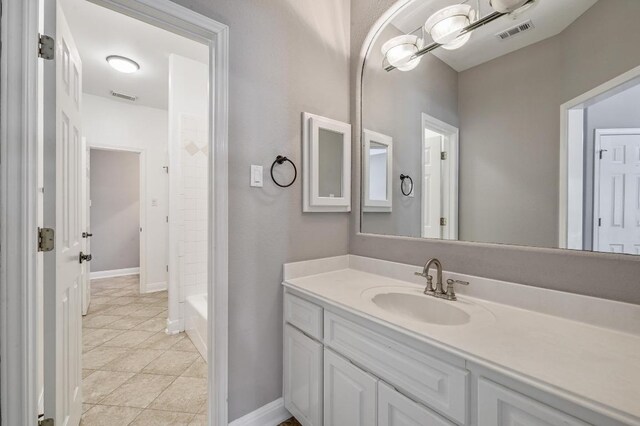 12004 Mira Mesa Dr, Austin, TX 78732 - full bathroom with vanity, tile patterned floors, and baseboards