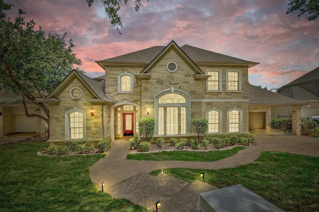 12004 Mira Mesa Dr, Austin, TX 78732 - french country home featuring stone siding, concrete driveway, a front yard, an attached garage, and a shingled roof