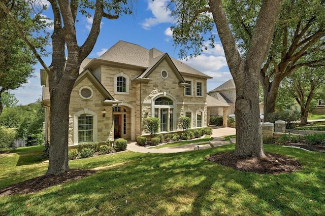 12004 Mira Mesa Dr, Austin, TX 78732 - french country home featuring stone siding and a front yard