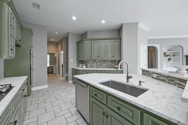 12004 Mira Mesa Dr, Austin, TX 78732 - kitchen featuring green cabinetry, a sink, stainless steel appliances, backsplash, and recessed lighting