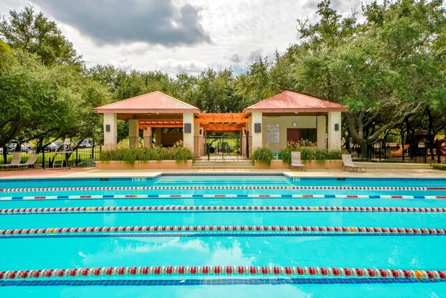 12004 Mira Mesa Dr, Austin, TX 78732 - community pool with view of wooded area