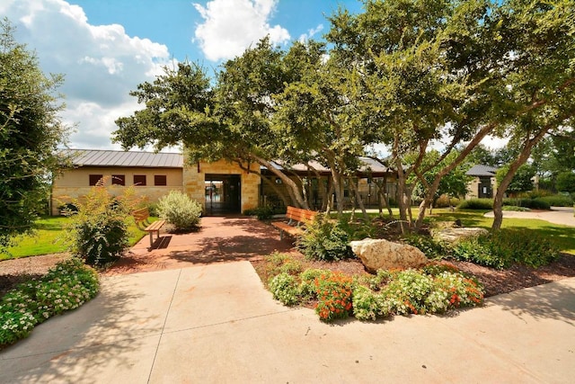 12004 Mira Mesa Dr, Austin, TX 78732 - view of front facade with stone siding and a standing seam roof