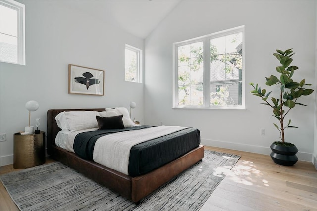 113 Nelray Blvd Unit 2, Austin, TX 78751 - bedroom with wood finished floors, vaulted ceiling, and baseboards