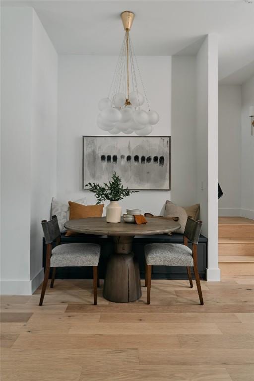 113 Nelray Blvd Unit 2, Austin, TX 78751 - dining space featuring breakfast area, a chandelier, baseboards, and light wood-type flooring