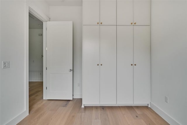 113 Nelray Blvd Unit 2, Austin, TX 78751 - unfurnished bedroom with light wood-style floors, a closet, and baseboards