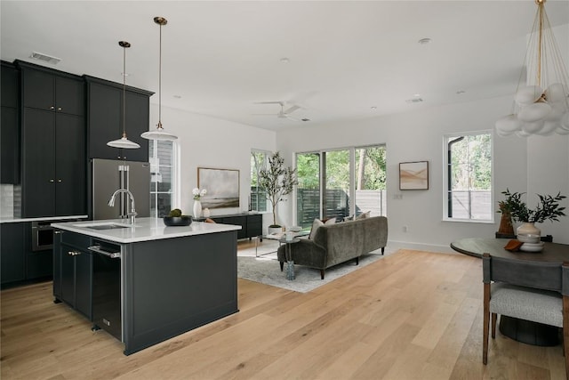 113 Nelray Blvd Unit 2, Austin, TX 78751 - kitchen featuring a sink, light wood-style flooring, light countertops, high quality fridge, and open floor plan