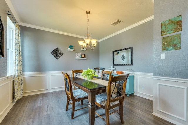 1414 Shamitas Ct, Leander, TX 78641 - dining space with plenty of natural light, dark wood-style floors, crown molding, a chandelier, and wainscoting