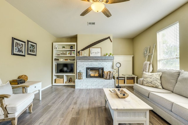 1414 Shamitas Ct, Leander, TX 78641 - living area with ceiling fan, wood finished floors, and a fireplace