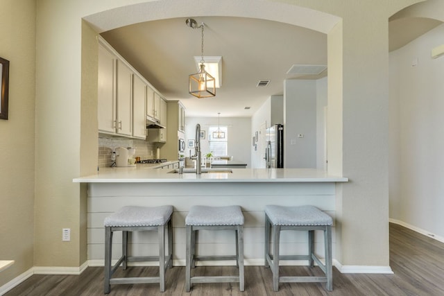 1414 Shamitas Ct, Leander, TX 78641 - kitchen featuring freestanding refrigerator, a sink, dark wood-type flooring, a peninsula, and baseboards