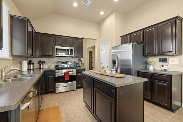 2217 Hilltop Climb Dr, Leander, TX 78641 - kitchen with stainless steel appliances, a sink, light tile patterned flooring, tasteful backsplash, and a kitchen island