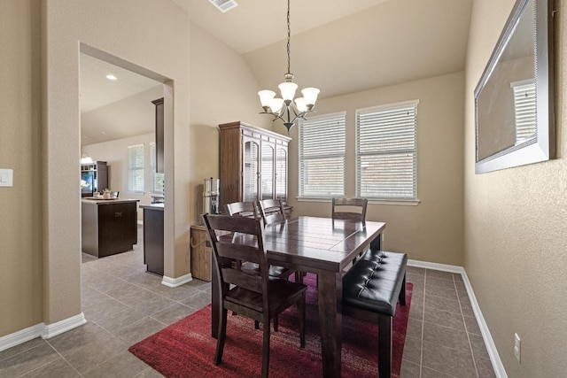 2217 Hilltop Climb Dr, Leander, TX 78641 - tiled dining area featuring a chandelier, lofted ceiling, and baseboards