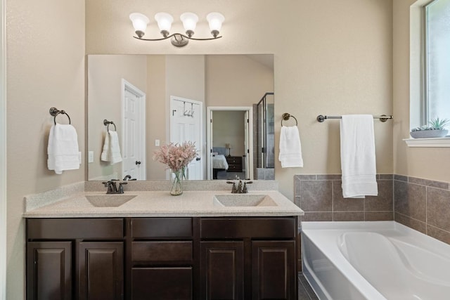2217 Hilltop Climb Dr, Leander, TX 78641 - ensuite bathroom with plenty of natural light, a bath, and double vanity