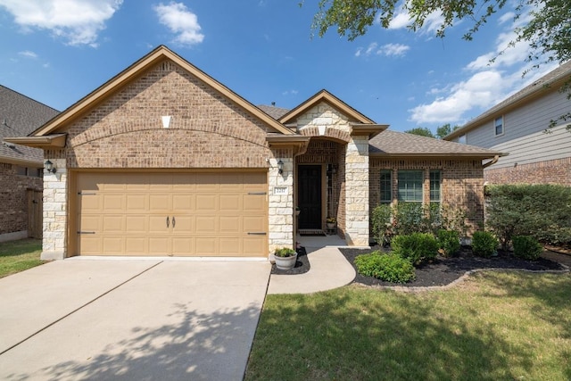 2217 Hilltop Climb Dr, Leander, TX 78641 - french provincial home with brick siding, driveway, an attached garage, stone siding, and a front yard