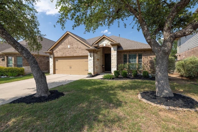 2217 Hilltop Climb Dr, Leander, TX 78641 - view of front facade with a garage, driveway, a front lawn, and brick siding