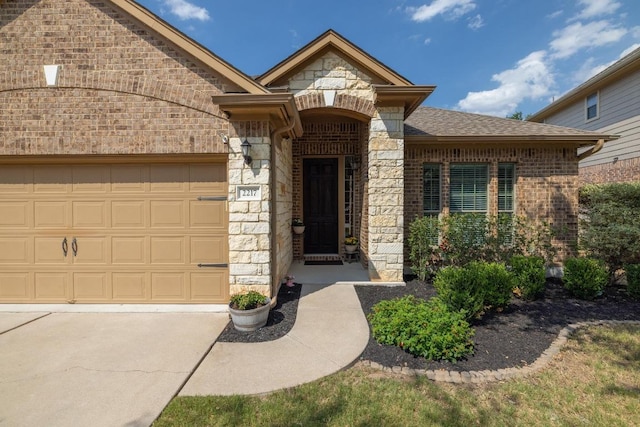 2217 Hilltop Climb Dr, Leander, TX 78641 - view of front of property featuring stone siding, an attached garage, brick siding, concrete driveway, and a shingled roof