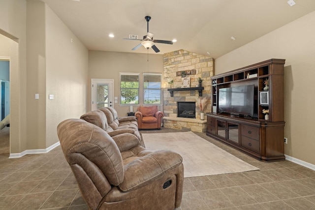 2217 Hilltop Climb Dr, Leander, TX 78641 - tiled living room featuring vaulted ceiling, ceiling fan, baseboards, and a stone fireplace