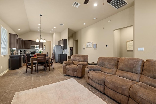 2217 Hilltop Climb Dr, Leander, TX 78641 - living area with light tile patterned floors, a ceiling fan, vaulted ceiling, a chandelier, and recessed lighting