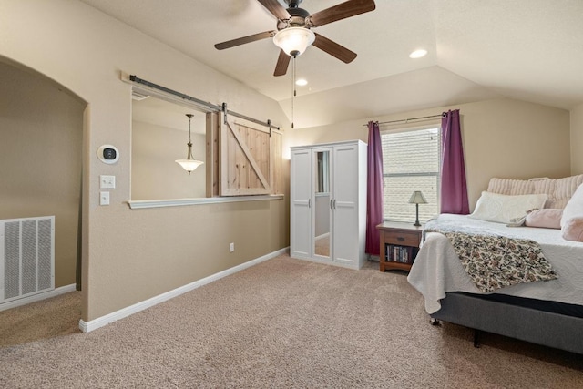 2217 Hilltop Climb Dr, Leander, TX 78641 - carpeted bedroom featuring a barn door, arched walkways, lofted ceiling, baseboards, and recessed lighting