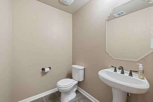 2217 Hilltop Climb Dr, Leander, TX 78641 - bathroom with toilet, tile patterned floors, baseboards, and a sink