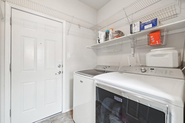 2632 Century Park Blvd Unit 38, Austin, TX 78727 - laundry area featuring washing machine and clothes dryer and light tile patterned floors