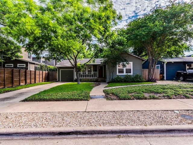1316 Arcadia Ave, Austin, TX 78757 - view of front of property with driveway, an attached garage, and a porch