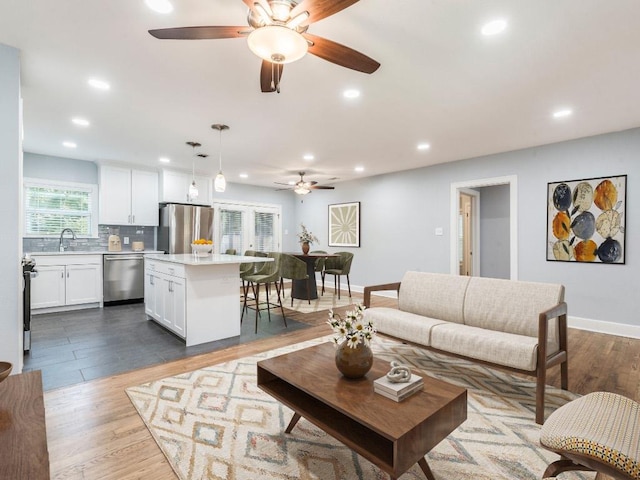 1316 Arcadia Ave, Austin, TX 78757 - living area with a ceiling fan, recessed lighting, wood finished floors, and baseboards