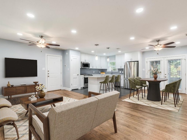 1316 Arcadia Ave, Austin, TX 78757 - living area featuring a ceiling fan, recessed lighting, wood finished floors, and baseboards
