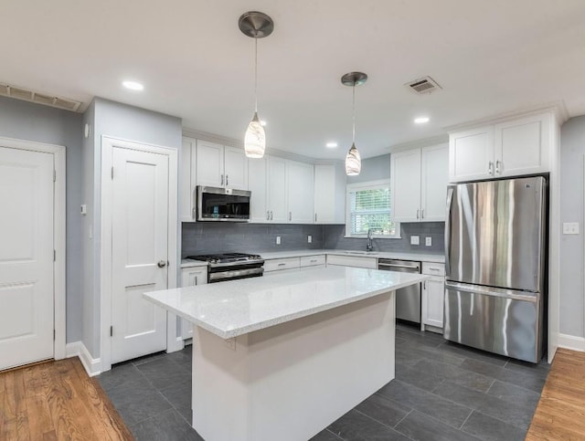 1316 Arcadia Ave, Austin, TX 78757 - kitchen with appliances with stainless steel finishes, a sink, white cabinetry, tasteful backsplash, and recessed lighting
